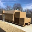Self contained compactor dog house enclosure right hand load
